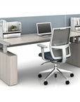 Modern office with power bench sit to stand desk setup with a chair, laptop, and printer in a minimalistic office. Kansas City Office Design.