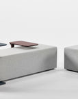 Two modern gray benches with adjustable Humanscale Float micro tables on a white background. Kansas City Office Design.
