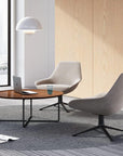 Friant Roke Coffee Table with raised edge and metal frame in office lounge area with natural light. Kansas City office furniture