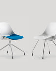 Two modern chairs with one having a blue seat on a light gray background. Kansas City Office Design