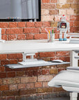 HumanScale keyboard tray meant for height adjustable desk. Pictured with a desk, chair, monitor against a brick wall. Kansas City Office Design.
