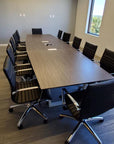 Vogue Conference Chair Mid-Back in Black PU around conference table - Kansas City Office Furniture