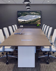 Conference room with a large table and chairs, featuring a screen displaying an outdoor scene. Kansas City Office Design.