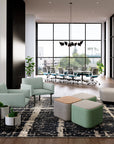Modern office lobby with green SitOnIt Cameo Club chairs, ottomans, and large windows. Kansas City Office Design.