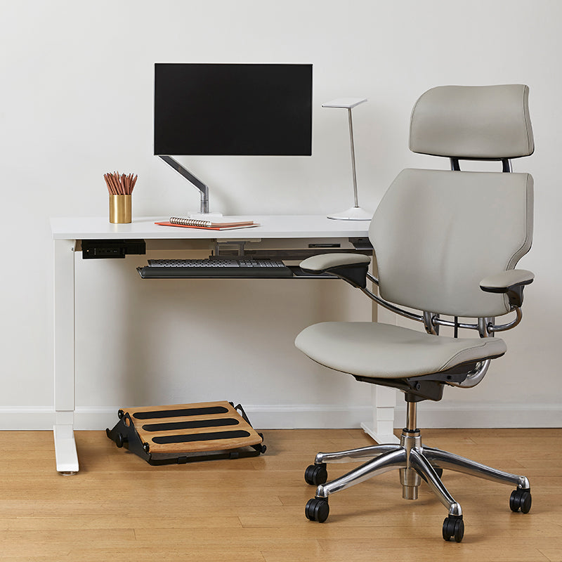 Modern office setup with a ergonomic chair, desk, and Humanscale FR300 footrest. Kansas City Office Design. 