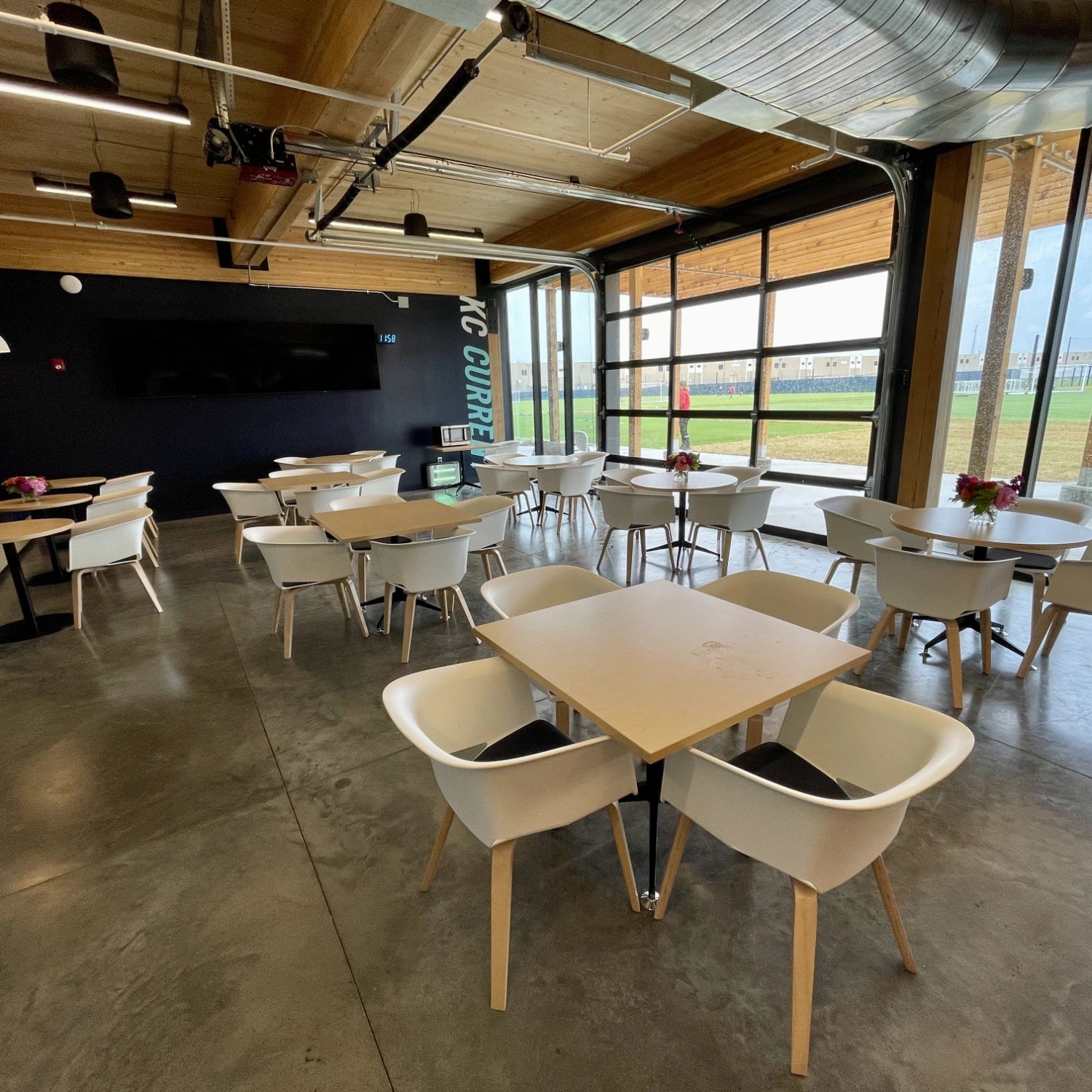 Install of Cafe Room with tables, chairs, and booth seating. Furniture: AIS & ERG. Kansas City Office Design.
