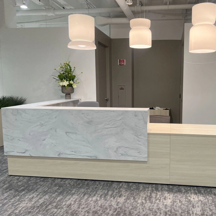 Modern reception desk with marble top in an office setting. Kansas City Office Design.