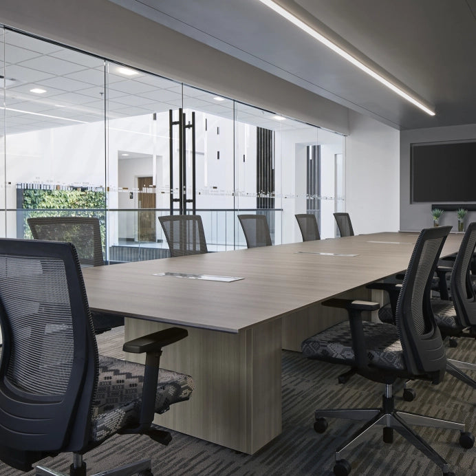 Modern office conference room with long wooden table and chairs. Kansas City Office Design.