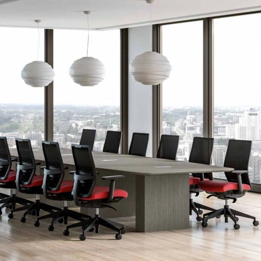 Modern conference room with a large table and chairs near large windows with a cityscape view. Kansas City Office Design.