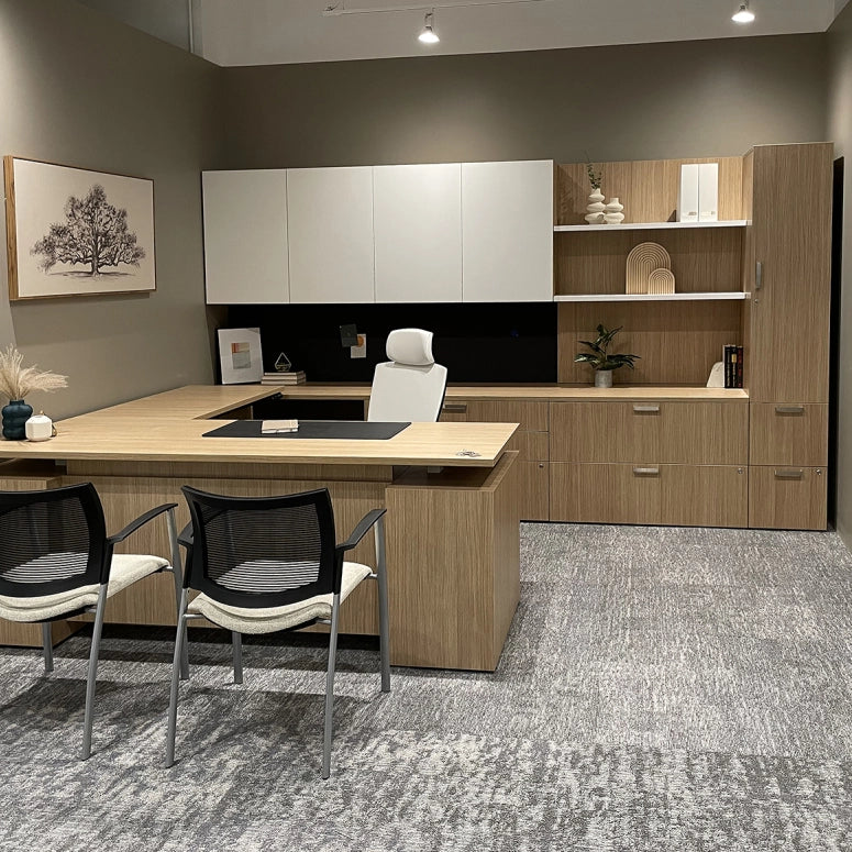 Modern office setup with a L-shaped desk, chairs, and shelves. Kansas City Office Design.