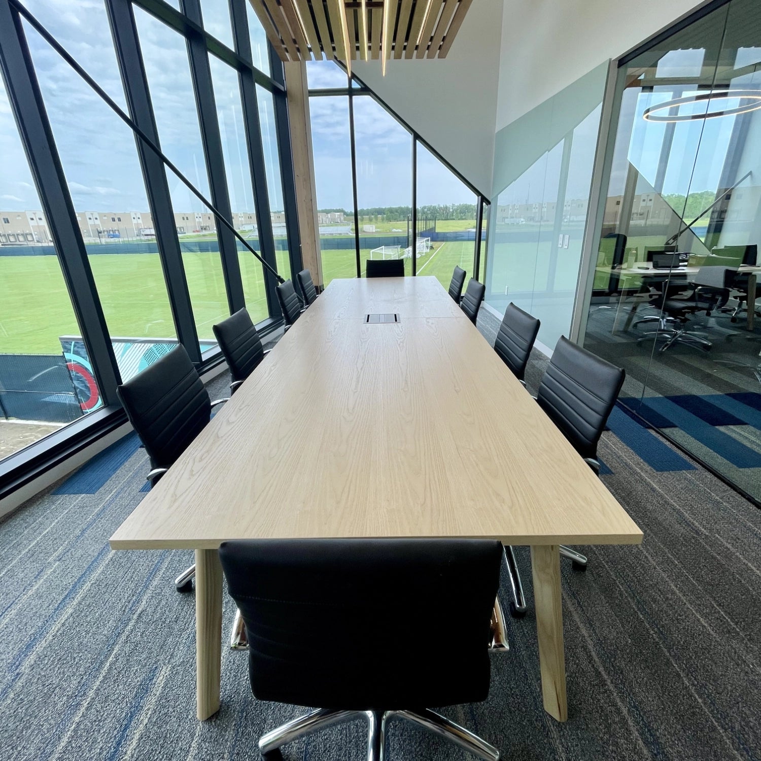 Wood Veneer Conference Table with power. This includes conference table, conference chairs. Furniture: Enwork & Clear Design. Kansas City Office Design.