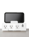 SitOnIt Current Multi-outlet strip with USB ports and a smartphone on a white background. Kansas City Office Design.