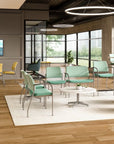 Modern office waiting area with green chairs, a coffee table, and large windows. Kansas City Office Design.