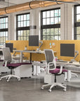 Modern office setup with desks, chairs, and large windows. Kansas City Office Design