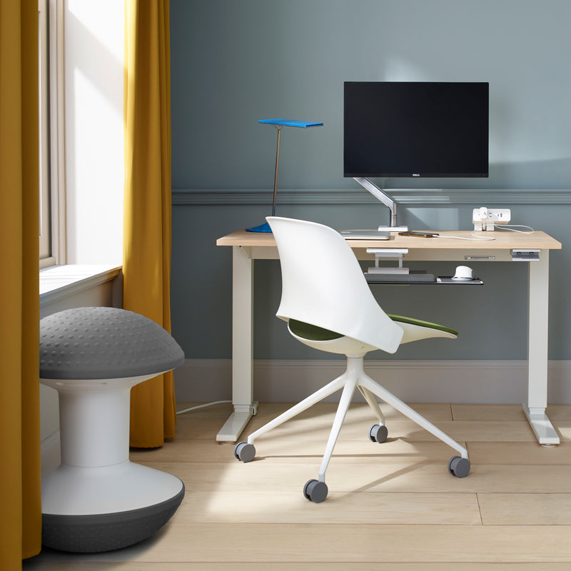 Modern home office with a desk, trea chair, and gray Humanscale Ballo Stool. Kansas City Office Design.