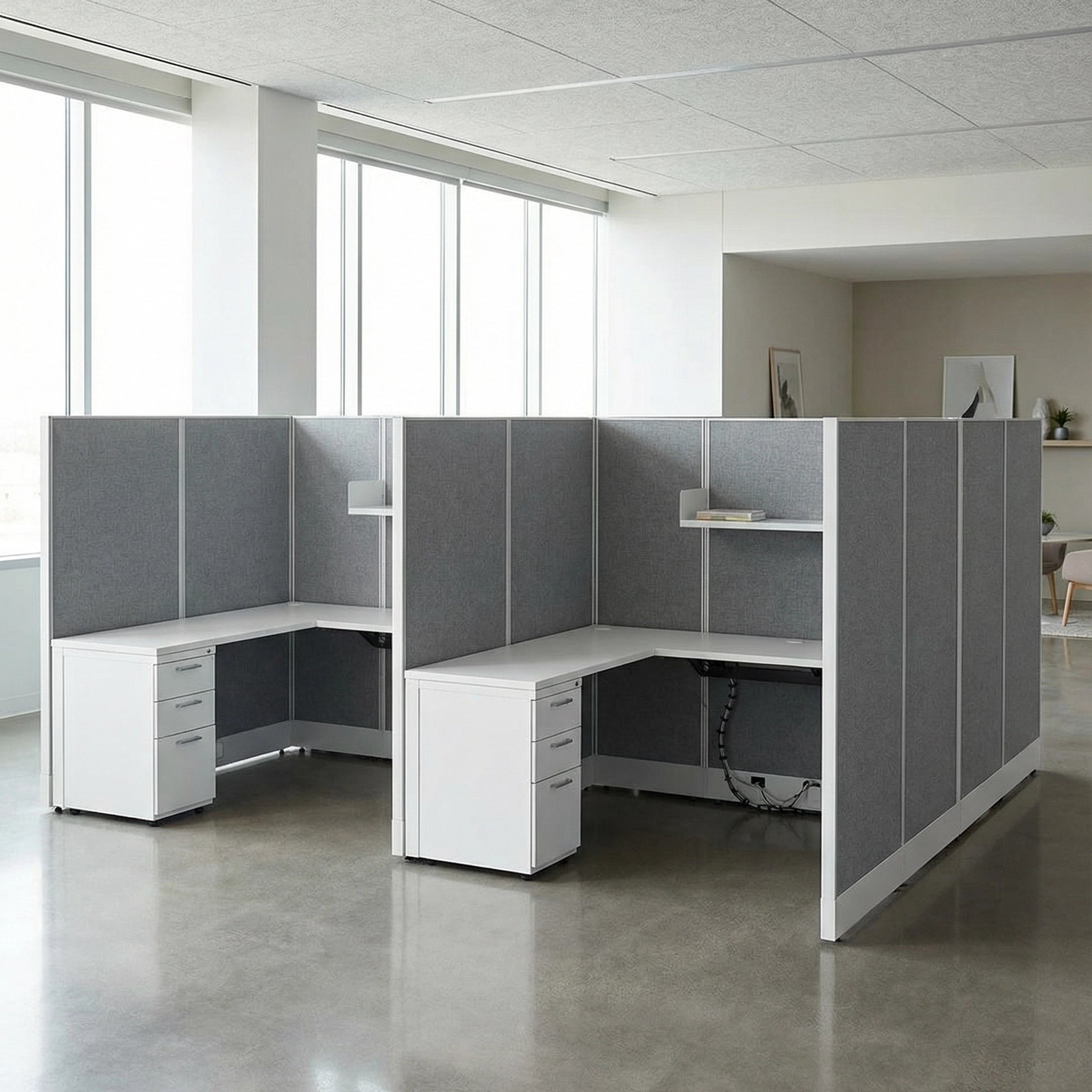 Modern office setup with L-shaped desk and gray partition walls. Kansas City Office Design