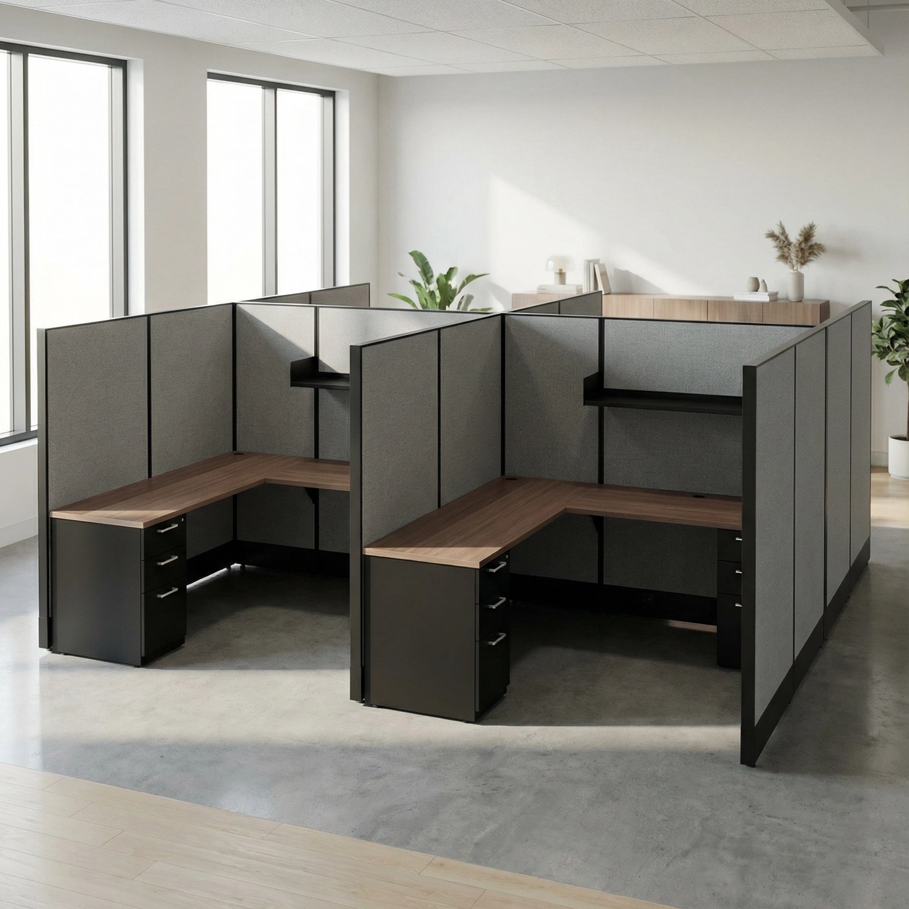 Modern office cubicle setup with wooden desks and gray partitions in a bright room. Kansas City Office Design