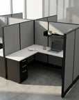 Modern office desk with partition walls in a well-lit room. Kansas City Office Design.