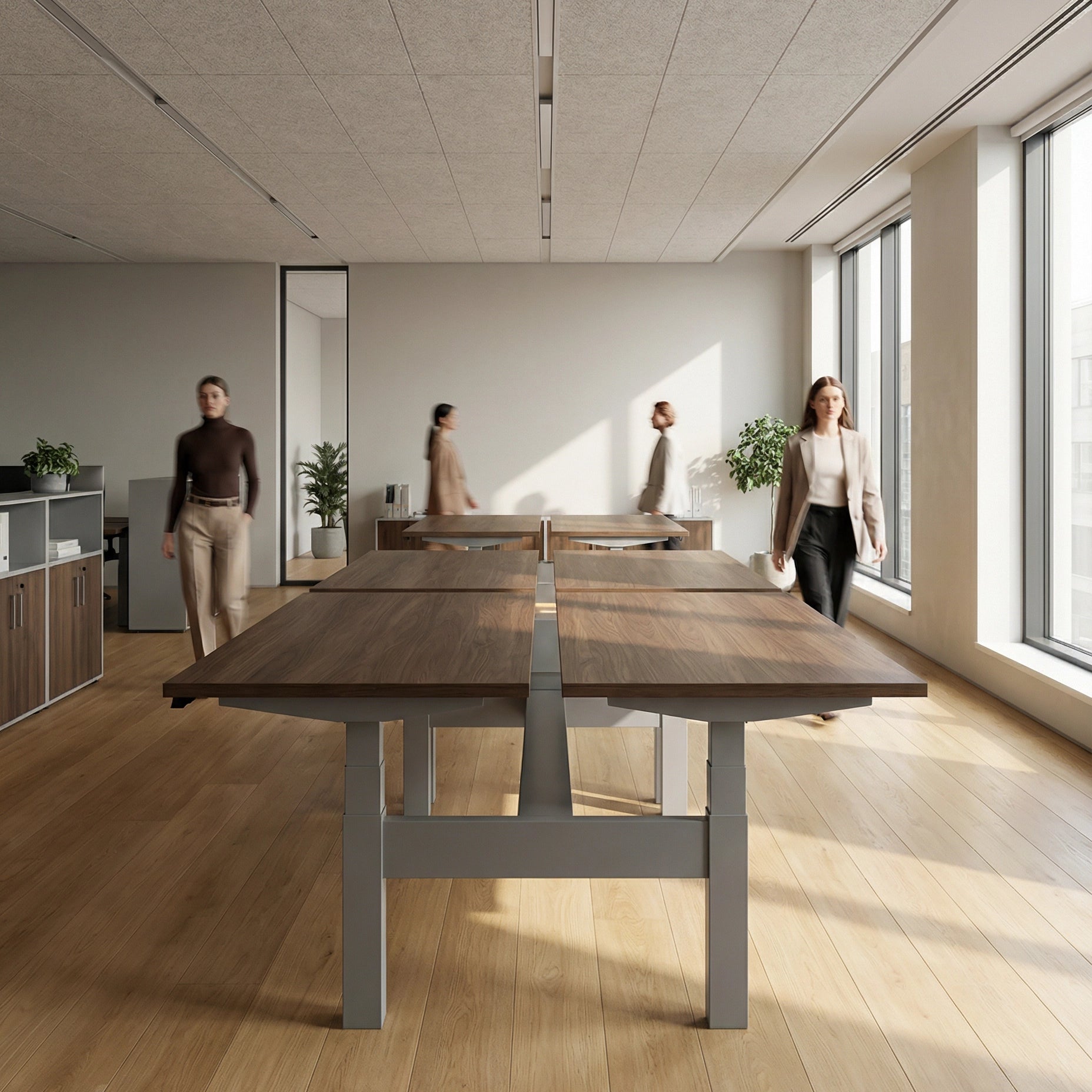 HAT Collective Height adjustable 4pod with Silver Base and walnut Tops with people working in an open office. Kansas City Office Design