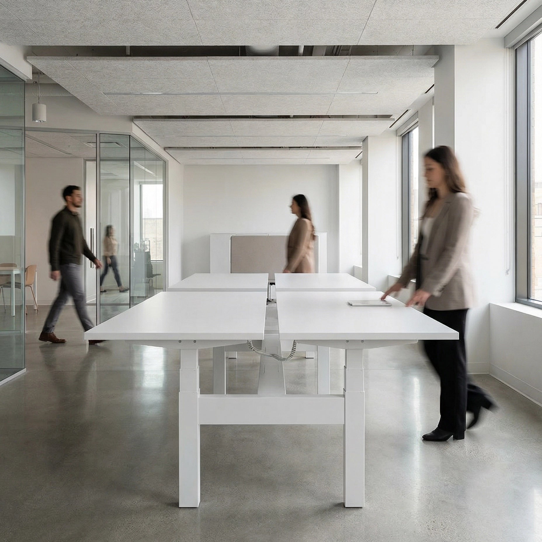 HAT Collective Height adjustable 4pod with white base and white tops with people working in an open office. Kansas City Office Design