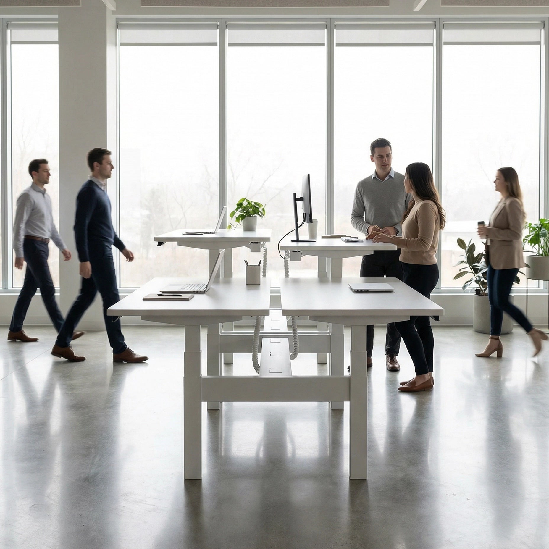 HAT Collective Height adjustable 4pod with white base and white tops with people working in an open office. Kansas City Office Design
