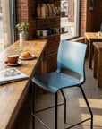 Cafe stool looking out the window with coffee and croissant. Kansas city office design.