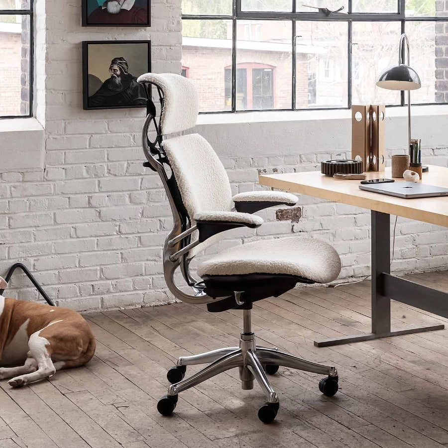 Ergonomic Humanscale Freedom office chair in a modern office setting with a desk and window. Kansas City Office Design.