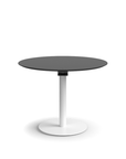 Humanscale Float Gather 36" round Table in white base with black laminate top in sitting position. Kansas City Office Design.