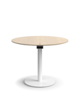 Humanscale Float Gather 36" round Table in white base with white oak veneer top in sitting position. Kansas City Office Design.