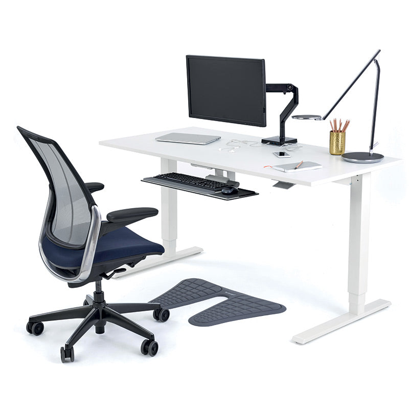 Modern office desk with chair, computer setup, and Humanscale Monarch Anti-fatigue mat in grey finish. Kansas City Office Design.