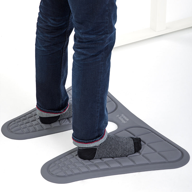Person standing on gray Humanscale Monarch Mat with blue jeans and black socks. Kansas City Office Design. 
