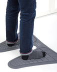 Person standing on gray Humanscale Monarch Mat with blue jeans and black socks. Kansas City Office Design. 