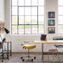 Humanscale saddle stool in a modern office space with a desk, chairs, and large windows. Kansas City Office Design.