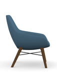 Side view of the 9to5 Lilly lounge chair in walnut wood leg frame and wave blue vinyl Fabric. Kansas City Office Design