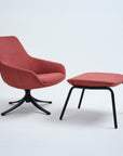 Red chair and ottoman with black legs on a white background. Kansas City Office Design.
