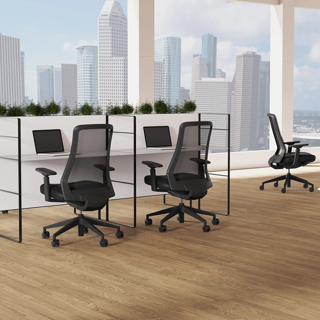 Modern office setup with black chairs and desk in front of a cityscape view. Kansas City Office Design