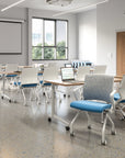 Modern classroom with desks and SitOnIt Movi nesting chairs in a well-lit room. Kansas City Office Design.