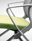 Modern office chair with green seat and gray frame on a white background. Kansas City Office Design.