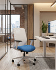 NeoLite Task Chair in a working environment with a height adjustable desk and glass walls. Kansas City Office Design.