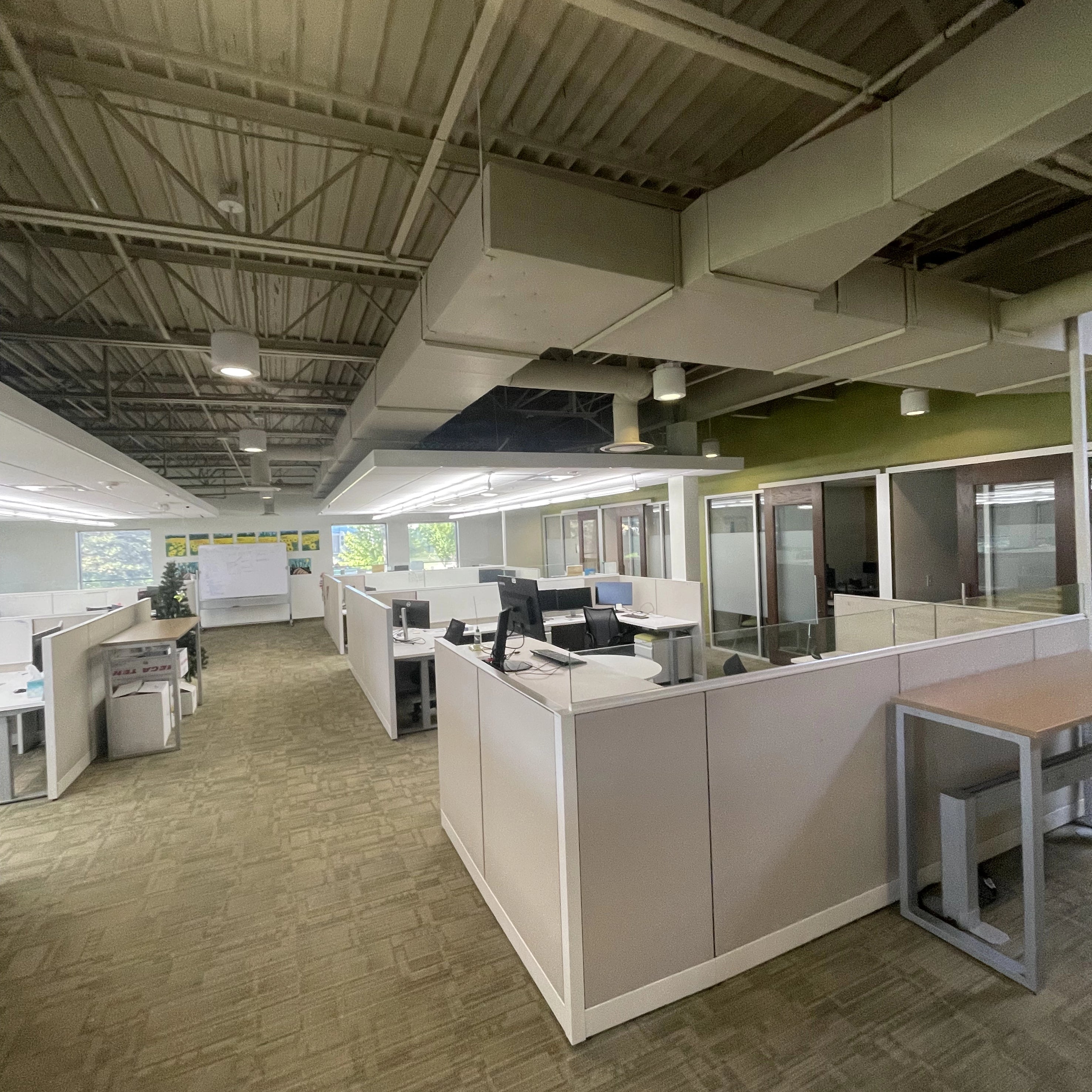 Modern office space with cubicles, humanscale liberty chairs, and large windows. Netsmart. Kansas City Office Design