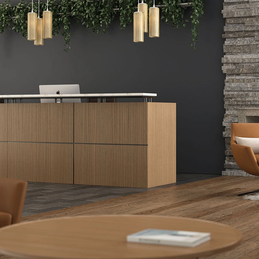 Modern office reception area with wooden desk, chairs, and decorative elements. Kansas City Office Design