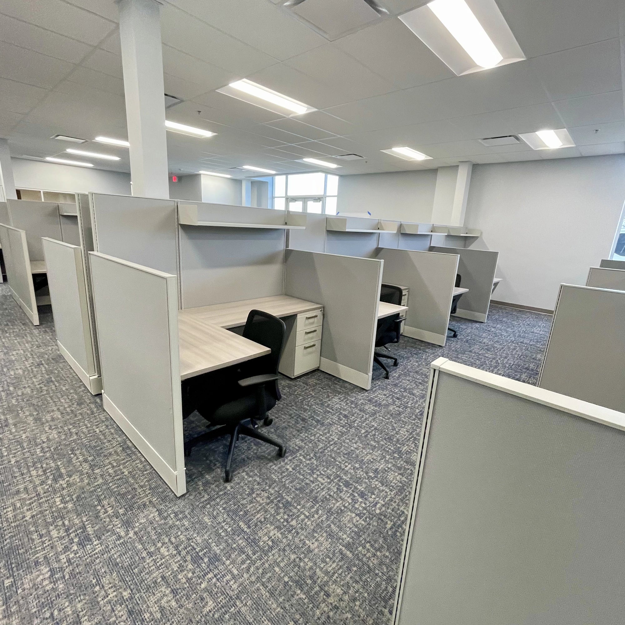 Modern office space with cubicles and desks. Orange Ev. Kansas City Office Design.