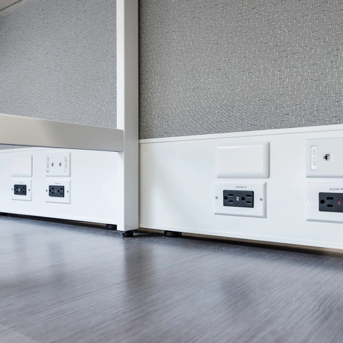 Close-up of office cubicle walls with power outlets and switches. Kansas City Office Design