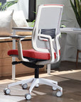 Modern SitOnIt Focus 2.0 office chair with red seat and white frame in a home office setting. Kansas City Office Design
