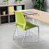 Green SitOnIt Lumin Stack chair in front of a wooden desk with a laptop and glasses in an office setting. Kansas City Office Design.