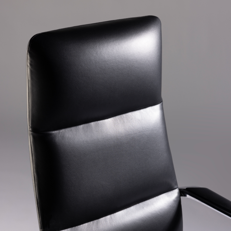 Black office chair with a gray background. Kansas City Office Design
