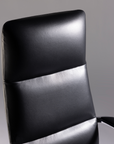 Black office chair with a gray background. Kansas City Office Design