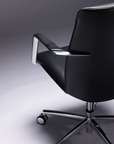 Black office chair with chrome base on a gray background. Kansas City Office Design