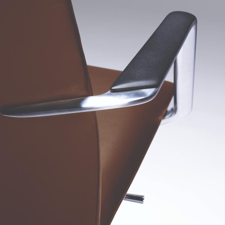 Close-up of a modern chair with brown seat and metallic armrests on a white background. Kansas City Office Design
