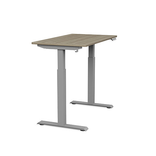 Side view of the SitonIt Switchback Height Adjustable Sit-to-Stand Desk. It has a Silver base with a 24"D x 42"W Sandalwood top - Kansas City Office Furniture
